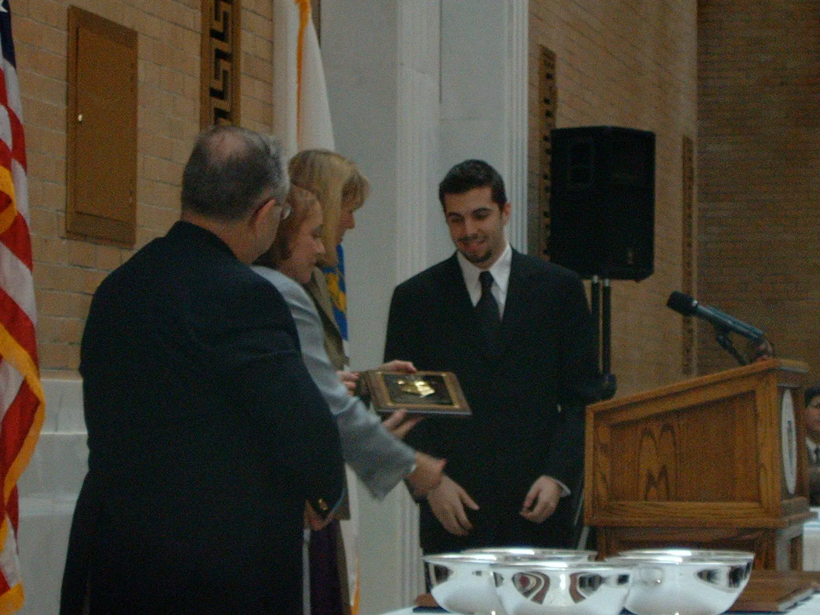 Danny Lourenço accepting the Eugene H. Rooney, Jr. Public Service Award on behalf of his father at the Great Hall of the State House, November 2004